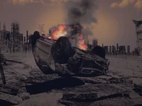 Горящая машина в руинах